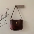 Retro dark brown oily leather shoulder bag with elegant golden metallic buckle - Coffee With Bear Pendant