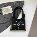 Minimalist black matte underarm bag with silver rivet studs on a gray background - Black