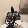 Elegante borsa a mano nera con stampe floreali colorate e chiusura a girello oro - Nero