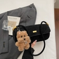 Detail view of black underarm bag with cute plush bear pendant on a white background - Black with Pendant