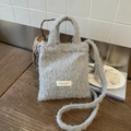 Winter plush soft tote bag in light grey faux fur with shoulder strap and brand label - Gray