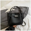 Elegant black lychee grain bucket bag with silver turn-lock clasp and shoulder strap - Black