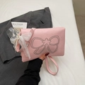 Detalle del bolso rosa con lazo de diamantes de imitación y colgante de perlas y encaje - Rosa