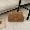 Detail of caramel brown leather handbag with contrast stitching and golden buckle - Brown