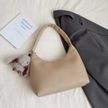Beige lychee leather crescent bag with grey plush bunny charm and wide shoulder strap - Beige With Charm