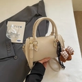 Chic beige Boston bag with crossbody strap, golden hardware and cute bear charm - With Charm / Off White