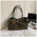 Olive green suede tote bag with decorative charms and gold buckle in lifestyle setting - Green with Pendant
