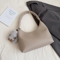 Minimalist khaki crescent shoulder bag with pebbled leather and plush charm detail - Elephant Gray with Charm