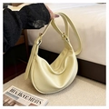 Detail of soft yellow hobo bag with pebble texture and gold adjustable buckles - Yellow