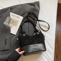 Minimalist black mixed-media bucket bag with gold hardware and adjustable strap - Black without Pendant