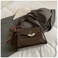 Dark brown retro crossbody bag with leopard bear charm and shiny finish on grey suit - With Charm / Brown