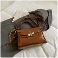 Classic dark brown leather handbag with silver twist lock and woven tassel pendant - With Charm / Brown
