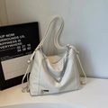 Dettaglio borsa tote beige in pelle con catena argentata spessa e ciondolo a cuore - Bianco Sporco