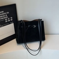 Classic black matte leather tote bag with silver buckle detail and thin shoulder straps - Black