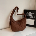 Detail of coffee quilted hobo shoulder bag featuring wavy stitching and a padded strap - Coffee