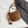 Chic brown leather bucket bag with ball charms and contrast stitching details - Brown