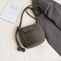 Deep grey-green bucket bag in matte suede finish with metal decor and tassels - Green
