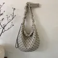 Detail view of beige plush tote bag with navy blue dots and stylish ruched shoulder strap - Beige Polka Dot