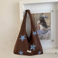 Detail of brown plush tote bag with light blue star embroidery and woven logo patch - Brown