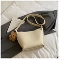 Chic beige bucket bag in lychee leather with a cute brown plush puppy charm - With Pendant / Off White