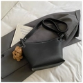 Minimalist black bucket bag with white contrast stitching and a plush puppy charm - With Pendant / Black