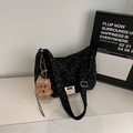 Detail of black corduroy tote bag with heart patterns and brown plush puppy charm - With Charm / Black