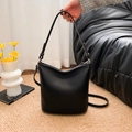 Minimalist black lychee-grain PU leather bucket bag with dual shoulder straps - Black