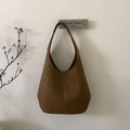 Detail of caramel brown matte leather tote bag with wide strap and vertical stitching - Brown