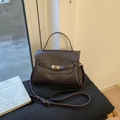 Vue détaillée du sac en cuir marron foncé avec boucle dorée et décor de livre rétro - Marron