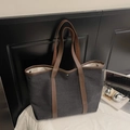 Dunkelgraue Canvas-Tote-Tasche mit braunen Ledergriffen auf weißem Bettzeug-Hintergrund - Schwarz