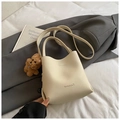 Creamy white lychee leather bucket bag with top handle and cute plush dog pendant charm - Beige With Charm