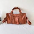 Orange brown PU leather Boston bag with vintage studs and tassels in a variant view - Brown