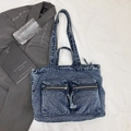 Dark blue washed denim tote bag with dual zipper pockets on white fabric background - Blue