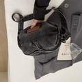 Chic black washed denim crossbody bag with adjustable wide strap and brown logo patch - Black