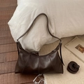 Detail of dark brown faux leather hobo bag with stitching accents and adjustable strap - Brown