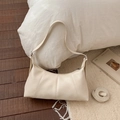 Detail of cream pleated faux leather hobo bag with zipper and adjustable shoulder strap - White