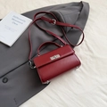 Classic dark red leather handbag with silver twist lock and adjustable shoulder strap - Red
