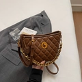 Brown quilted crossbody bag with gold chain strap and turn-lock closure in lifestyle setting - Brown