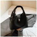 Bolso tipo cubo minimalista en cuero negro con cierre giratorio de metal plateado - Negro