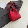 Elegant red pebbled leather bucket bag with silver twist lock and crossbody strap - Red (No Pendant)
