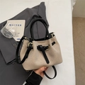Chic beige woven bucket bag with black leather trim and elegant gold hardware accents - No Pendant / Black