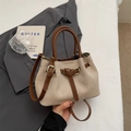 Elegant beige canvas bucket bag with brown leather straps and gold metal buckles - No Pendant / Brown