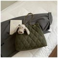 Close-up of olive green quilted suede shoulder bag with gold chain and plush bunny charm - With Charm / Green