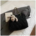 Quilted black tote bag with gold chain strap and plush rabbit charm on a grey blazer - With Charm / Black