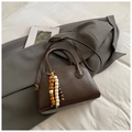 Vintage dark brown bowling pillow bag with beaded charm and double top handles - Brown