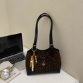 Detalle de bolso de leopardo con lazo negro y colgante de corazón en escena de escritorio - Negro & Marrón Con Colgante