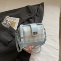 Detail of light blue checkered patchwork handbag with silver chain and twist lock - Blue