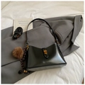 Detail of black leather tote bag with gold clasp, fuzzy pendant and two shoulder straps - Black With Pendant