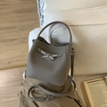 Chic dark grey lychee pattern leather bucket bag with silver buckle on a cozy sofa - No Pendant / Gray