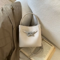 Cream textured leather bucket bag with silver metal twist lock and top handle - No Pendant / White